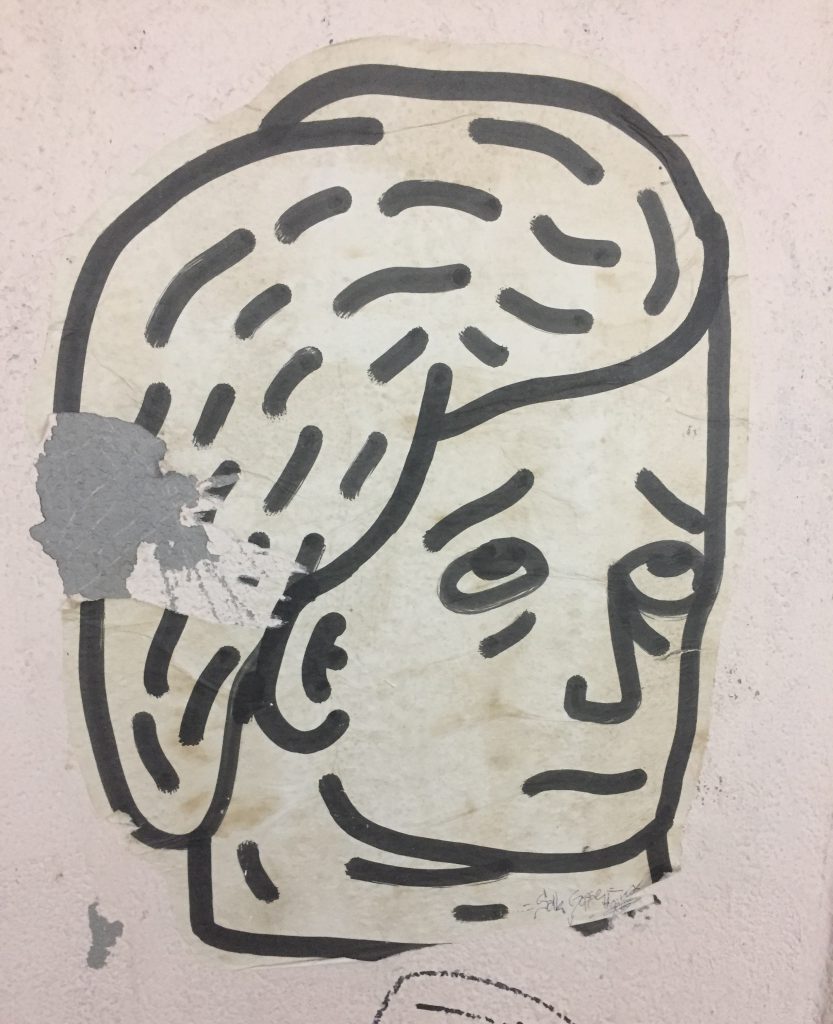 "Un homme triste." Peinture sur papier, artiste et année de productions inconnus. L'homme triste peut s'observer sur l'un des murs au haut du passage "Arlaud", qui relie la Riponne au théâtre Boulimie.